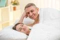 The lovers couple lay on the bed Photo