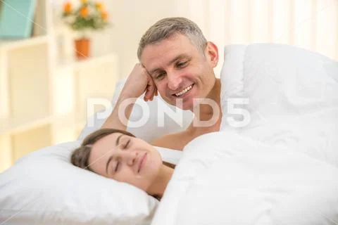 The lovers couple lay on the bed Stock Photos