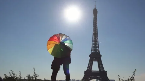 Lovers couple silhouette under multicolor umbrella near Eiffel Tower Stock Footage 263991174