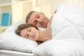The lovers couple sleeping on the bed Photo