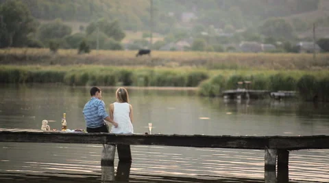 Lovers drinking champagne on the lake Stock Footage 63565270