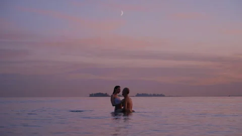 Lovers Embracing in the Ocean Waves During Golden Hour Stock-Footage 316360086