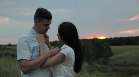 Lovers in the field. Care. Sunset Stock Footage 65729723