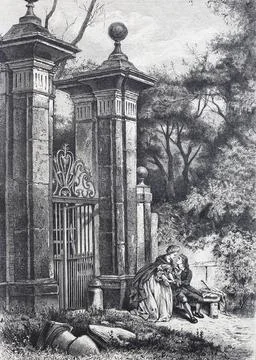 Lovers in front of the gate to a park sitting on a bench and looking at each Stock Photos