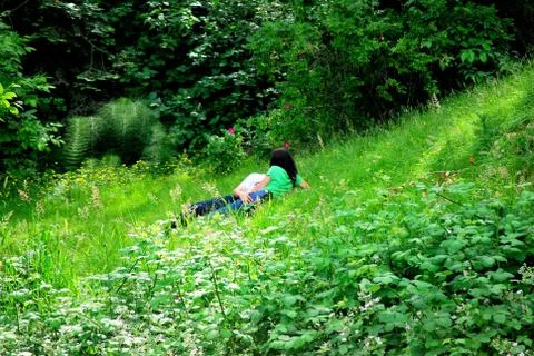 Lovers in the grass. Stock Photos