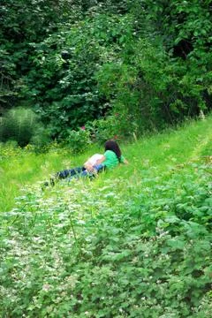 Lovers in the grass. Stock Photos