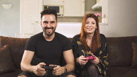Lovers having fun playing video games watching television TV at home, chilling Stock-Footage 129866572