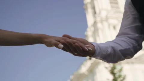 Lovers hold hands against the background of the temple and the sky Stock Footage 296486686