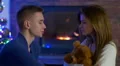 The lovers in the house by the fireplace and New Year tree background 4k or 4k+ Resolution