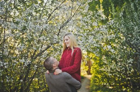 Lovers hugging on the background of flowering trees 1454. Stock Photos