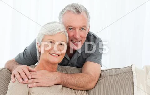 Lovers hugging while they are looking at the camera Stock Photos