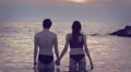 Lovers kissing in the sea at sunset - love - man and woman kiss - Lovers kissing HD Footage