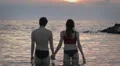 Lovers kissing in the sea at sunset - love - man and woman kiss - Lovers kissing HD Footage
