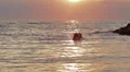 Lovers kissing in the sea at sunset - love - man and woman kiss HD Footage