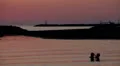 Lovers kissing in the sea at sunset - love - man and woman kiss HD Footage