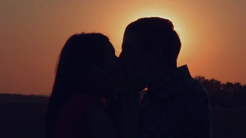 Lovers kissing at sunset Stock Footage 107670435