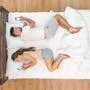 The lovers lay on the bed and phone. View from above Photo