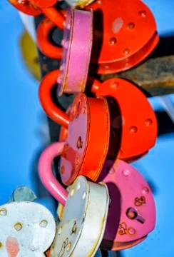 Lovers locks on the pole of the bridge and key thrown into the river. Stock Photos