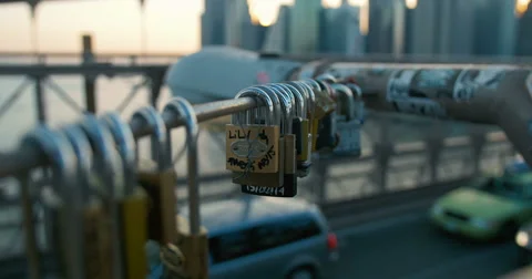 Lovers' locks swing in the wind over traffic on Brooklyn Bridge New York City Stock Footage 55466615