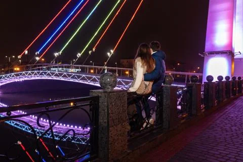Lovers look at the bridge Stock Photos