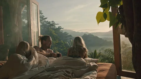 Lovers lying in bed with an amazing view Stock Footage 269466992