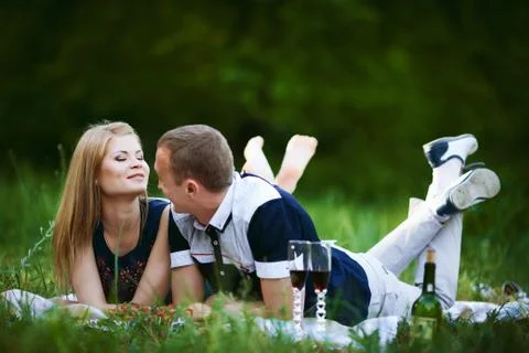 Lovers lying on grass Stock Photos