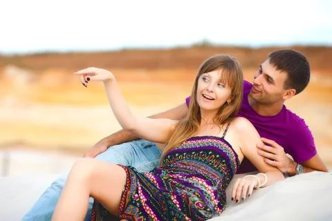 Lovers lying on sand Stock Photos
