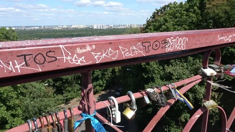 Lovers padlocks on railing of bridge with view on Kiev city Stock Footage 120484104