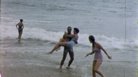 LOVERS PLAY IN THE WAVES Surf Beach 1960s Vintage Retro Film Home Movie 5316 Stock Footage 12409093