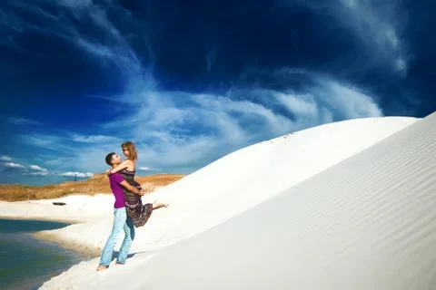 Lovers playing on beach Stock Photos