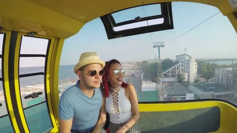 Lovers in a ropeway sightseeing the seaside Stock Footage 71998102