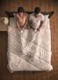 The lovers sit on the bed and phone. view from above Photo