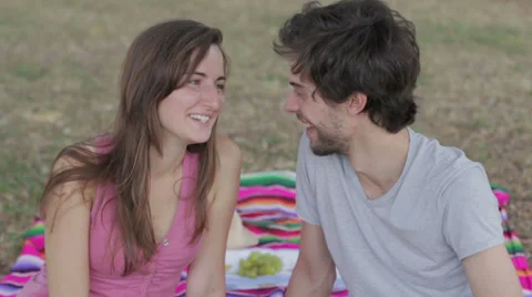 Lovers smiling and laughing at the camera , in the park Stock Footage 28498799
