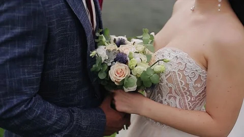Lovers stand next to each other and between them a beautiful bouquet Stock Footage 149428854