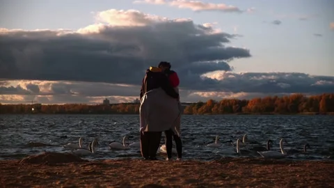 Lovers stand on the shore of the lake Stock Footage 219955437