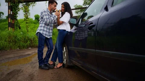 Lovers standing together having cone near vehicle Stock Footage 300352097