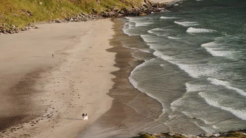 Lovers walk along the beach, waves Stock Footage 131105937