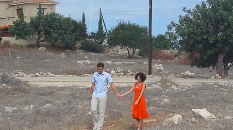 Lovers walking in a field Stock Footage 60581282