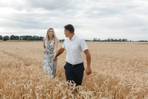 Lovers on the wheat field Stock Photos