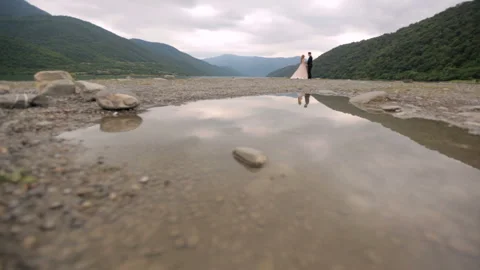 Loving couple on the background of the river and mountains Stock Footage 86610751