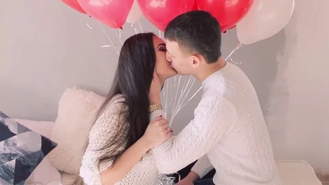 Loving couple on the bed with balloons 動画素材 74138524