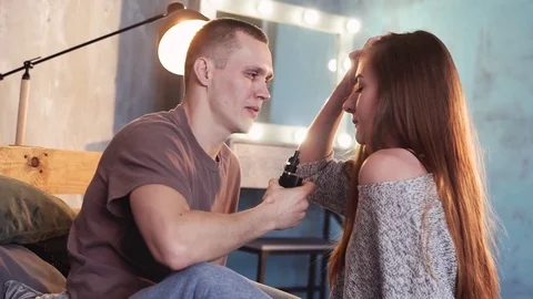 A loving couple on a bed smokes electronic cigarettes. Stock Footage 103160409