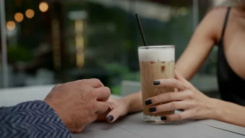 Loving couple in cafe, closeup of hands of lovers on table, man and woman are Stockbeeldmateriaal 163753781
