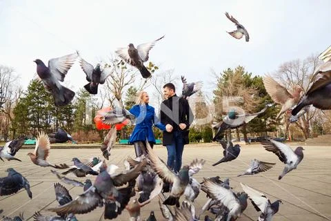 A loving couple in a coat with balloons of hearts in their hands Stock Photos