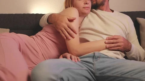 Loving couple cuddling closely on soft sofa, feeling intimate connection wh.. Stock Footage 305695238