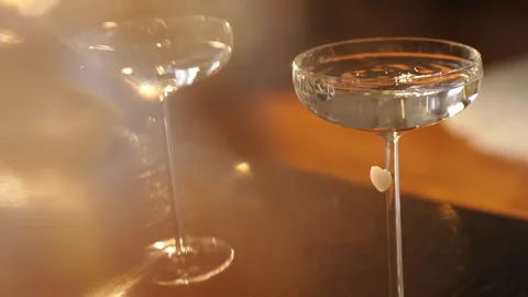 A loving couple on a date drinking an alcoholic cocktail near a fireplace Stockbeeldmateriaal 333827200
