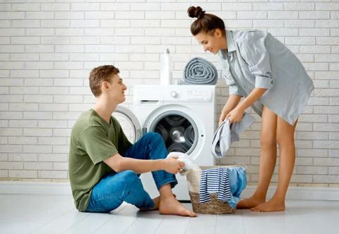Loving couple is doing laundry Stock Photos