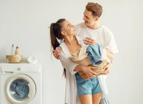 Loving couple is doing laundry Stock Photos
