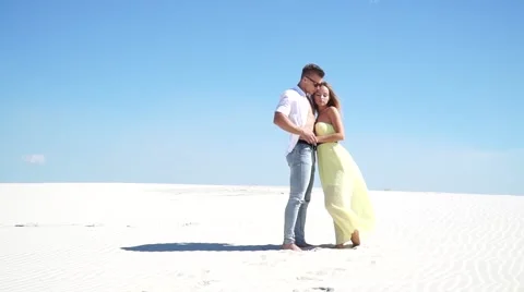 Loving couple embracing in the desert in the wind Stock Footage
