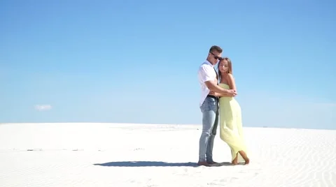 Loving couple embracing in the desert in the wind Stock Footage